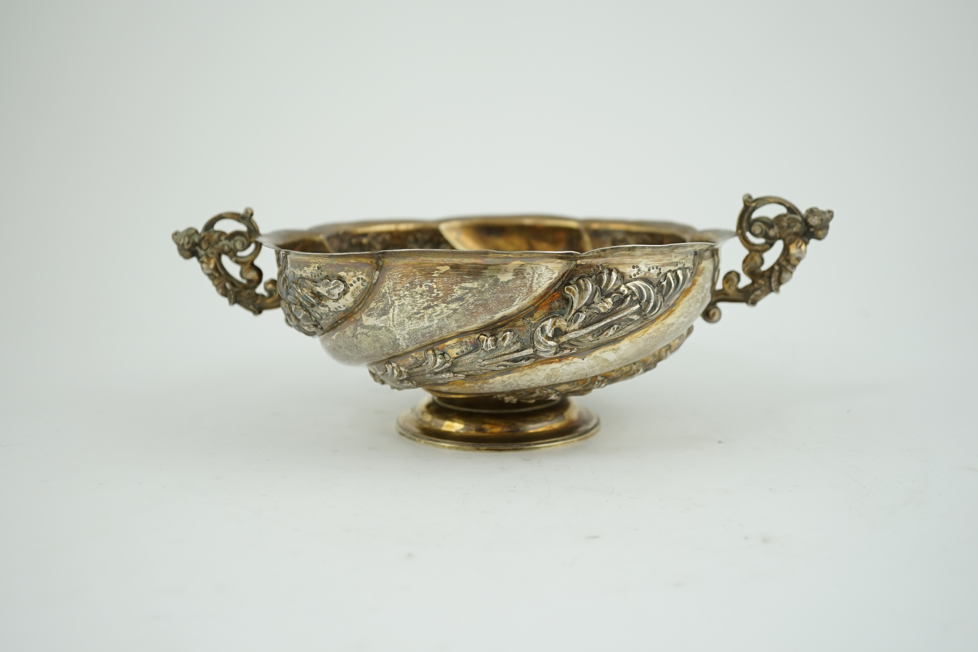 A late Victorian repousse silver two handled fruit bowl, by Charles Stuart Harris